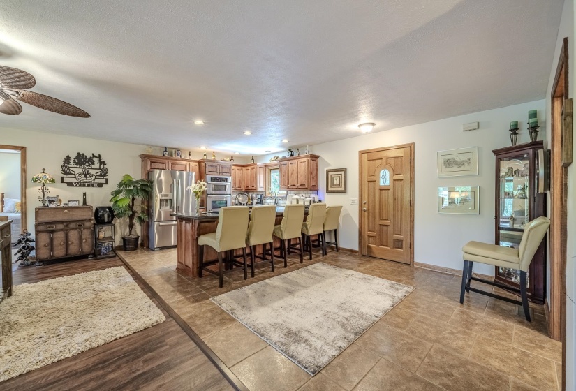 Open-concept kitchen and living area featuring wood-finish flooring and tile