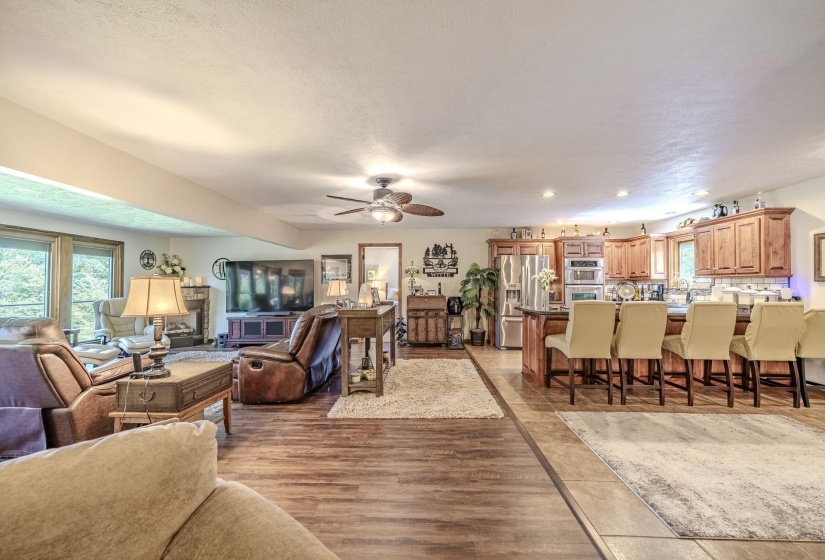 Expansive living space featuring wood-finish flooring and an integrated kitchen
