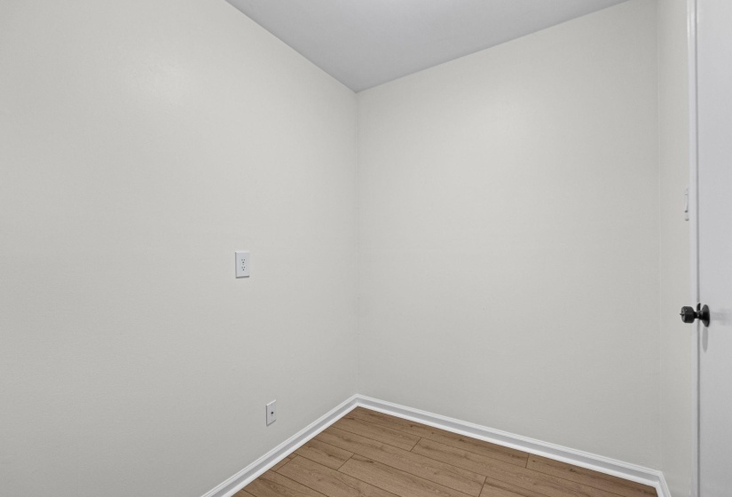 Neutral wall tones with wood-finish flooring