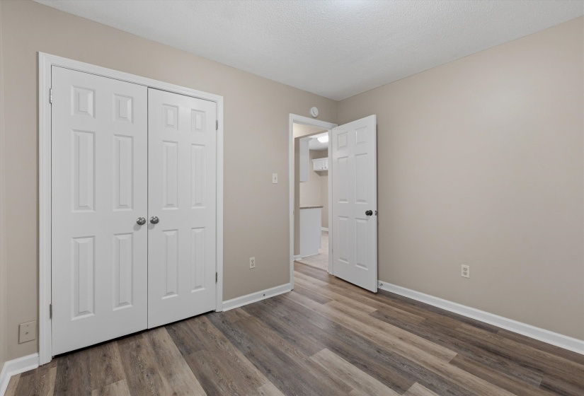 Neutral tone walls with white trim and wood-finish flooring