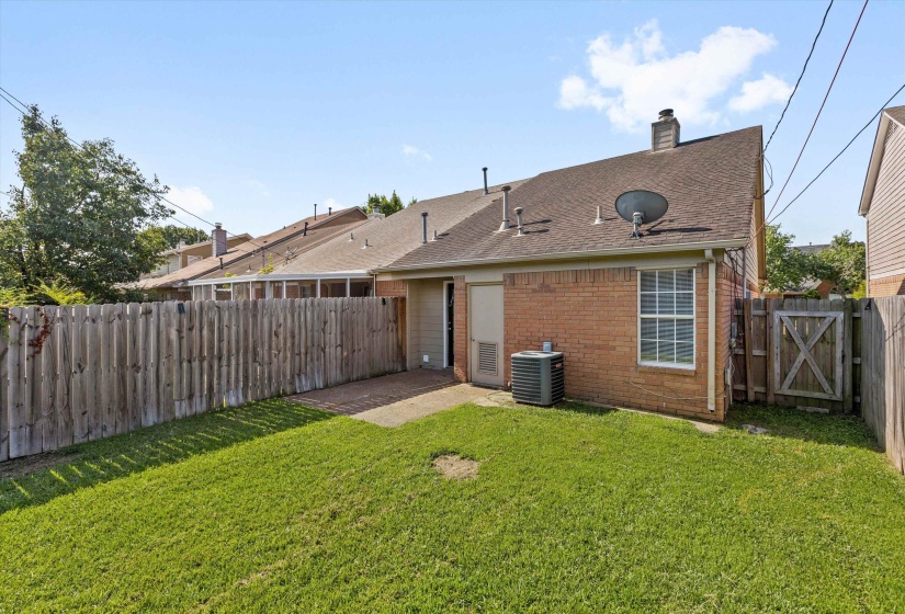 Expansive grassy yard with a full privacy fence