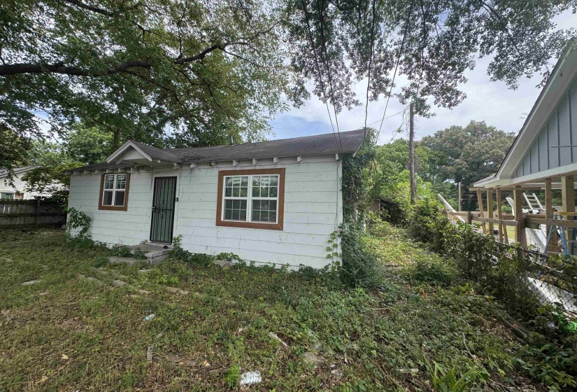 Single-story structure with white siding and brown trim