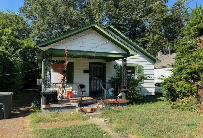White siding exterior with green trim accents