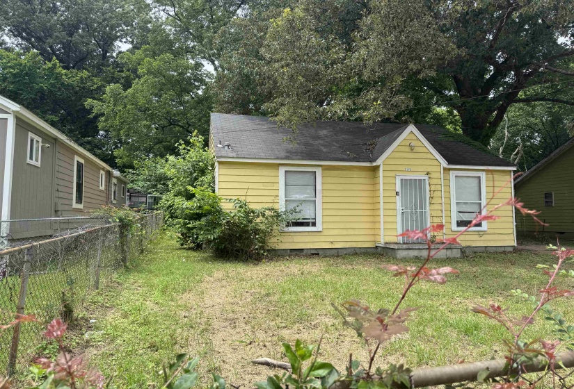 Yellow exterior with a gable roof and white window trim
