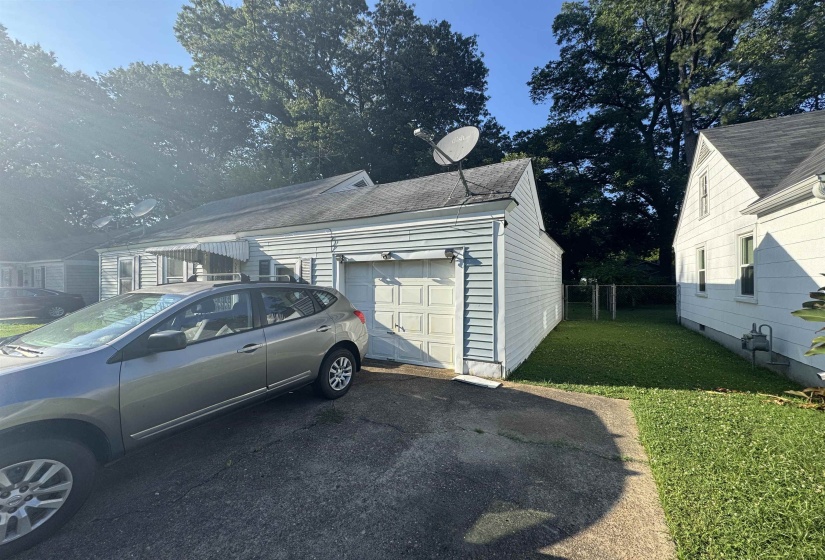 Single-story property featuring light-colored siding and a driveway