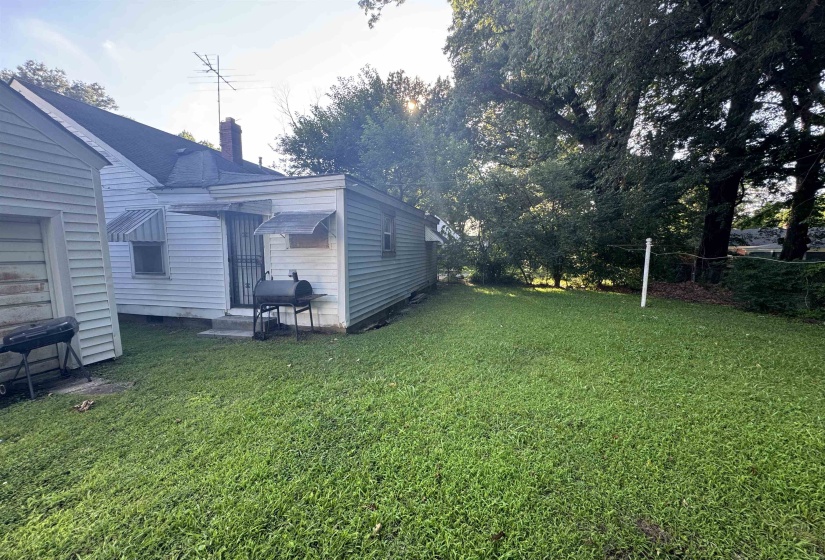 Expansive grassy yard with mature trees
