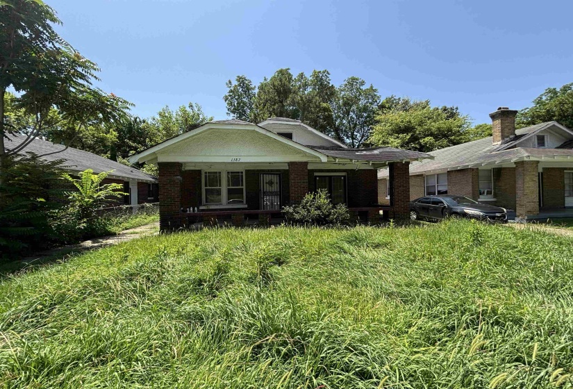 Brick bungalow with a covered front porch and a gabled roofline