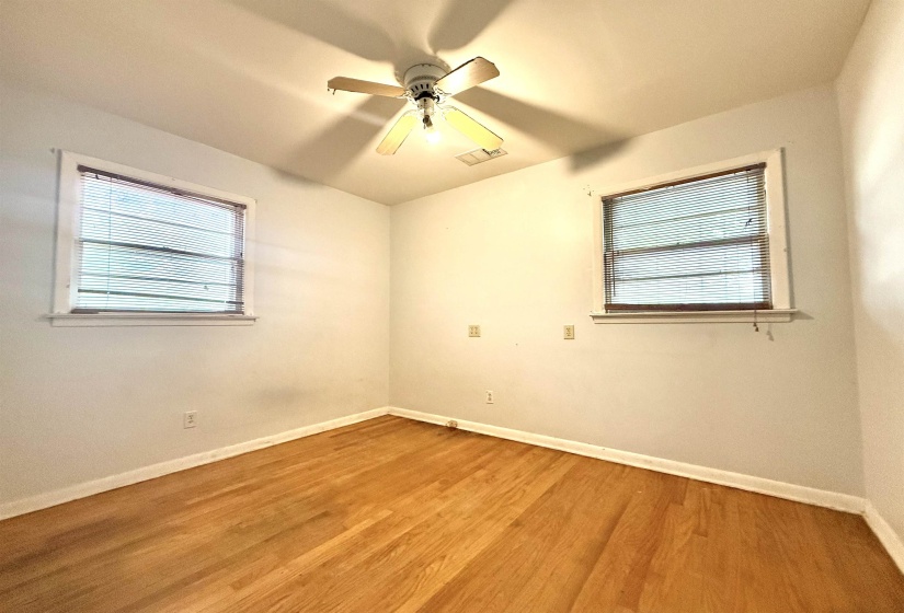 Hardwood flooring paired with a ceiling fan light fixture