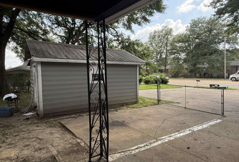 Detached outbuilding with metal roof and horizontal siding