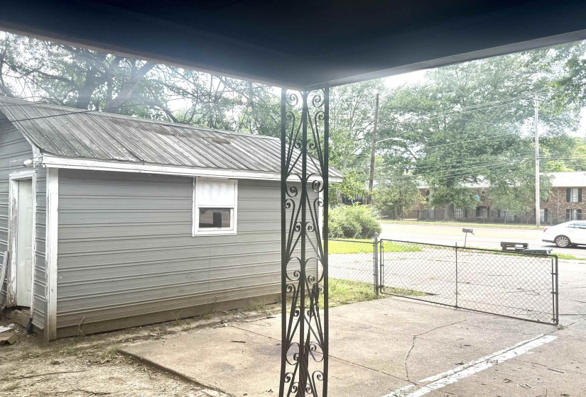 Detached utility building with metal roofing, horizontal siding, and a single window