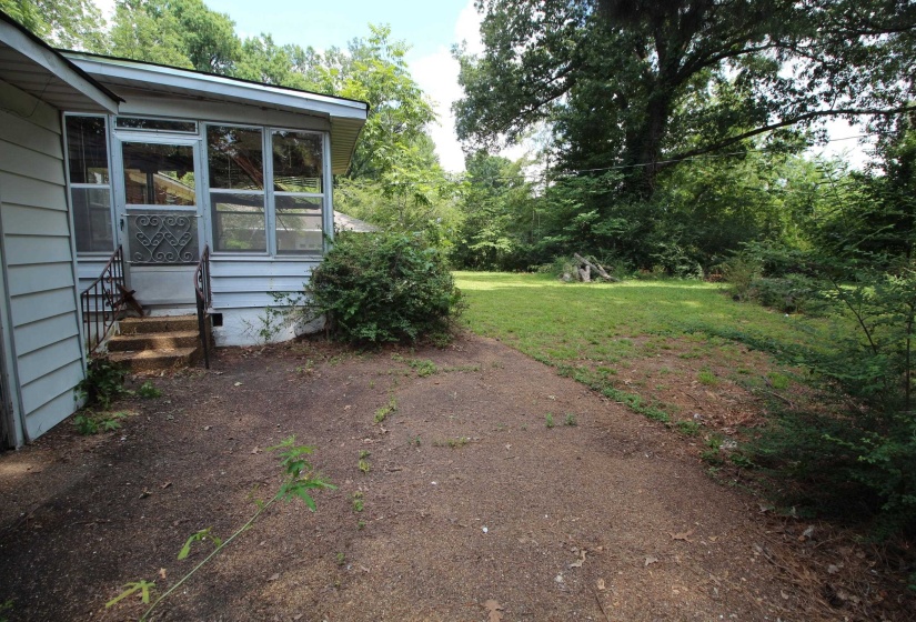 Screened porch with light blue siding, exterior metal railing, and concrete steps