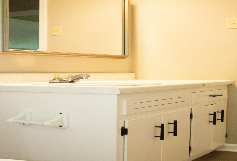 Bathroom vanity with a white countertop and integrated sink