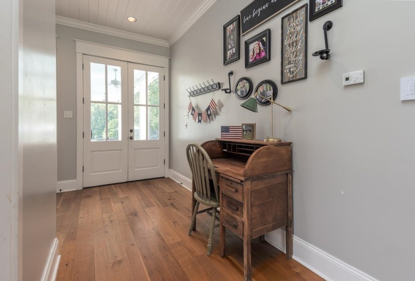 Entryway featuring double French doors with transom windows, wood-finish flooring, and a beadboard ceiling