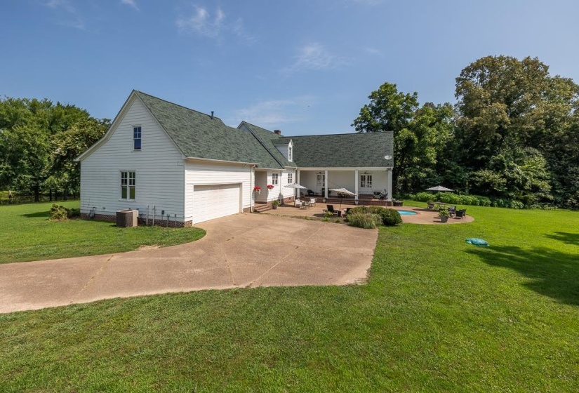 White siding exterior with a green shingle roof