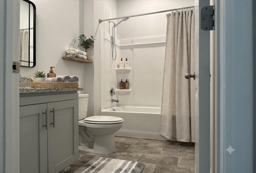 Bathroom featuring a tub/shower combination with a built-in shelf, a toilet, a vanity with a light-colored countertop, and a mirror