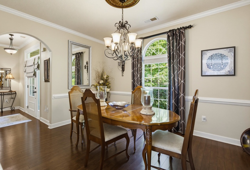 Formal dining area featuring rich wood-finish flooring off the front entry and kitchen making it great for entertaining guests