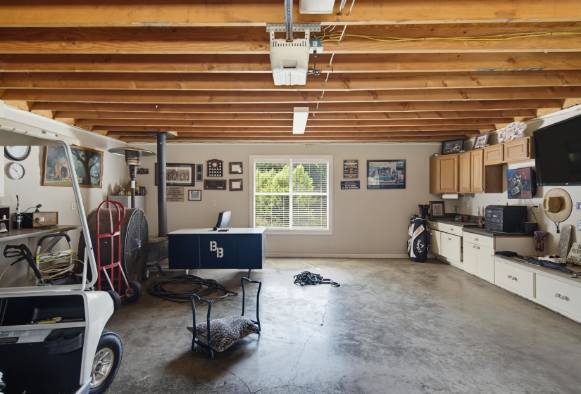 Spacious detached garage with built in cabinets and view of the lake.