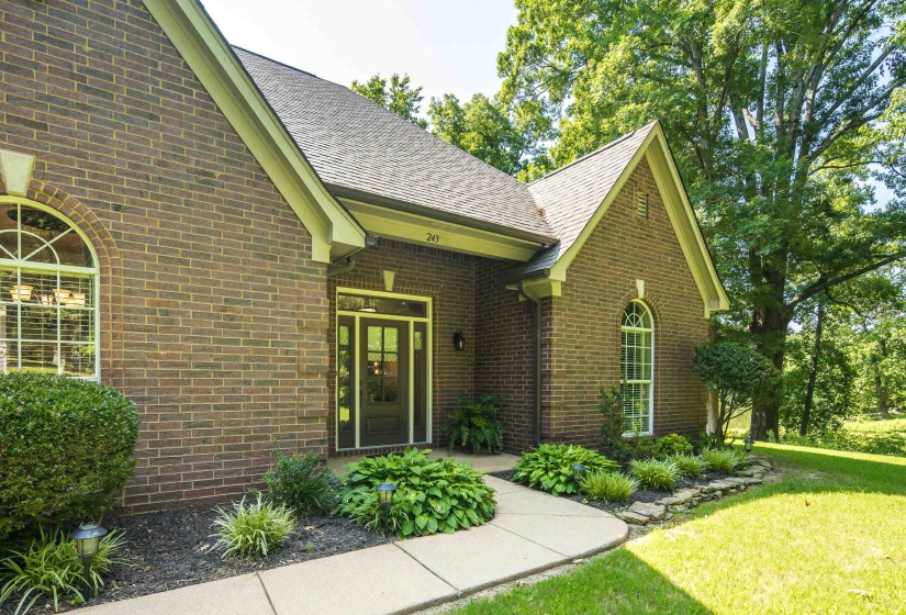 Landscaped sidewalk area to front entrance of home.