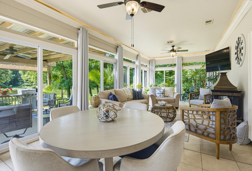 Florida-Style sunroom encased in sliding glass doors overlooking lake