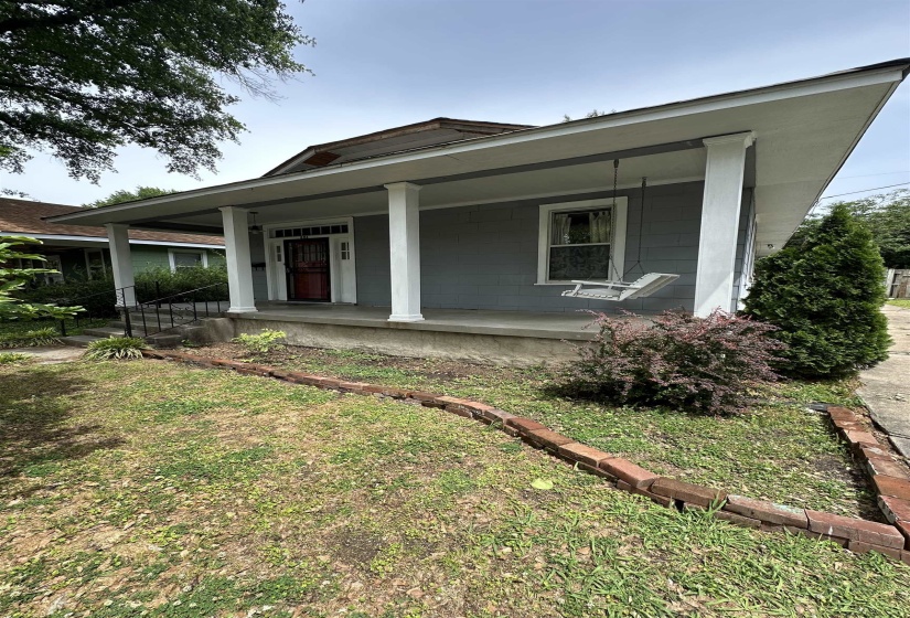 Exterior showcasing a covered front porch with white columns, a red entry door with sidelights, and a light gray siding finish