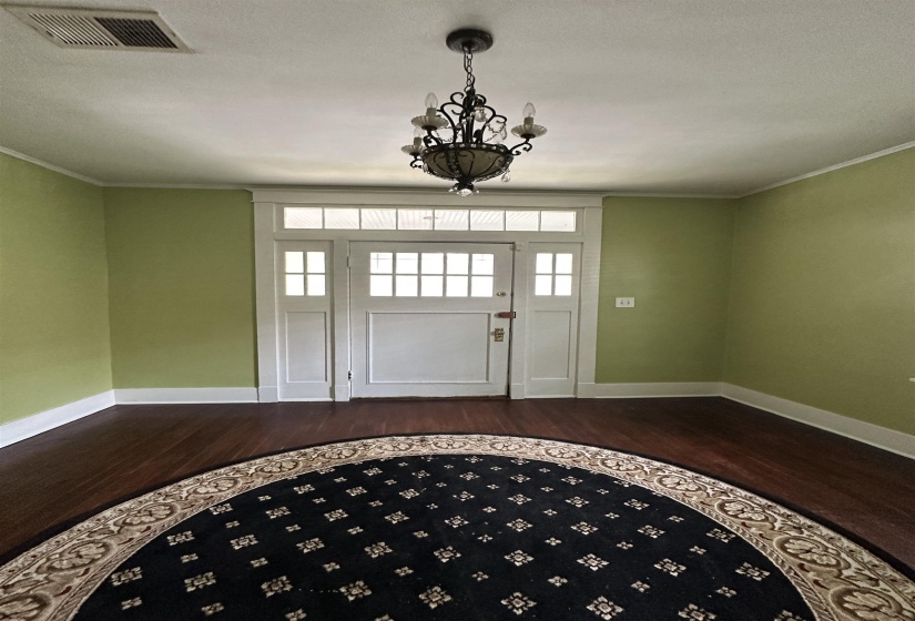 Entryway featuring a decorative transom window and sidelights