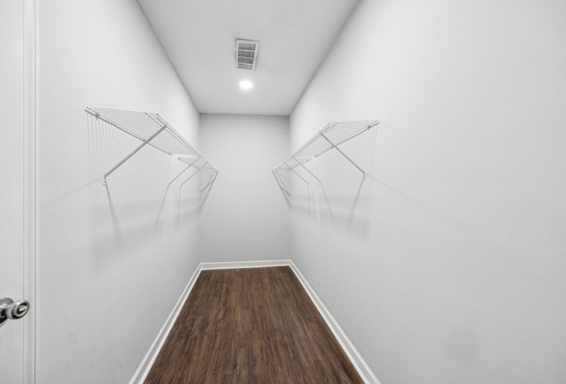 Walk in closet featuring dark wood-style flooring