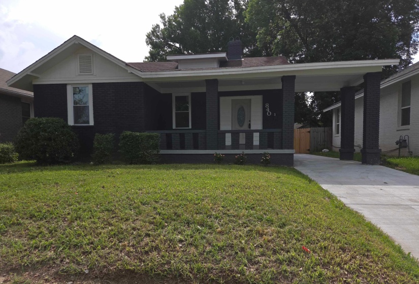 Brick exterior with a covered front porch featuring square columns