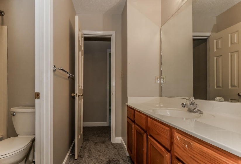 Bathroom vanity featuring a white countertop with an integrated sink and chrome faucet