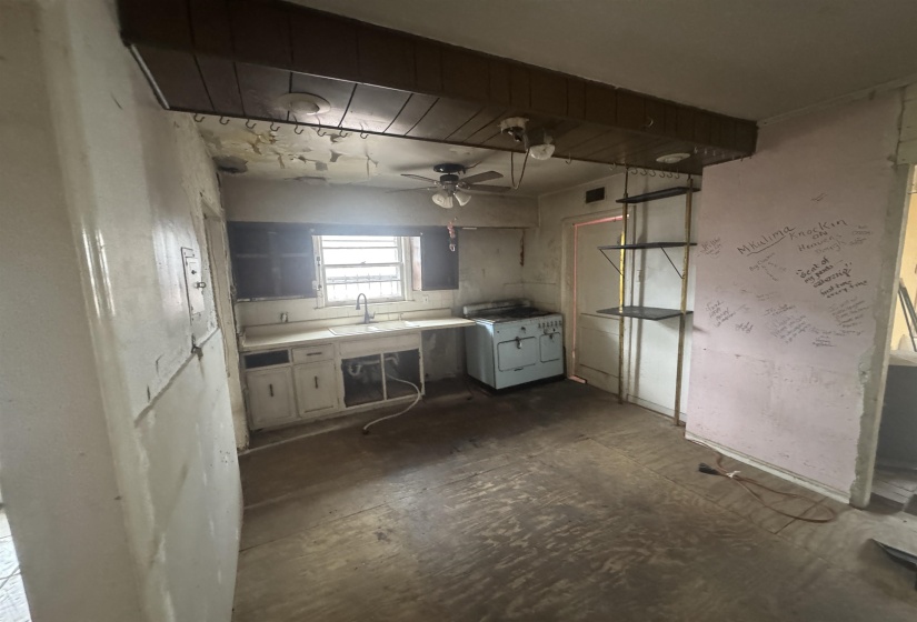 Kitchen featuring light countertops, a ceiling fan, and white stove