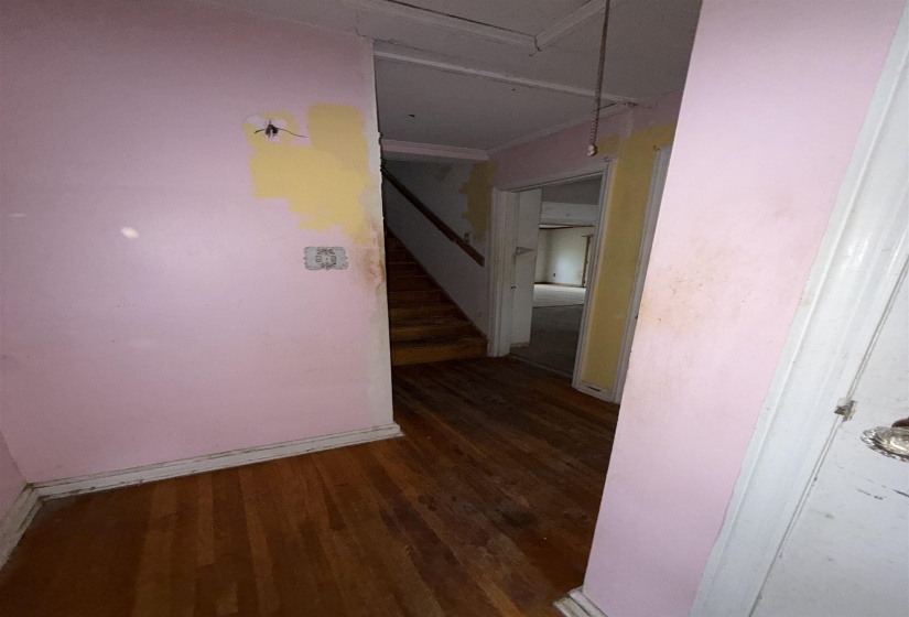Corridor with dark wood finished floors and stairs