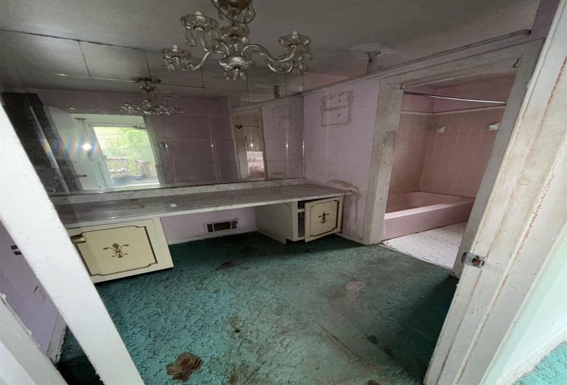 Full bathroom featuring vanity, bathing tub / shower combination, and suspended lighting
