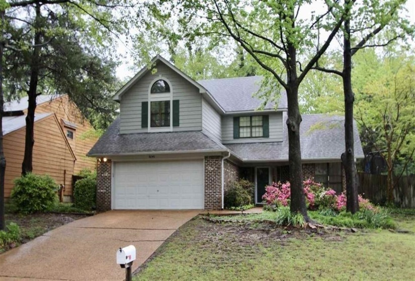 Traditional two-story residence featuring a brick and siding facade