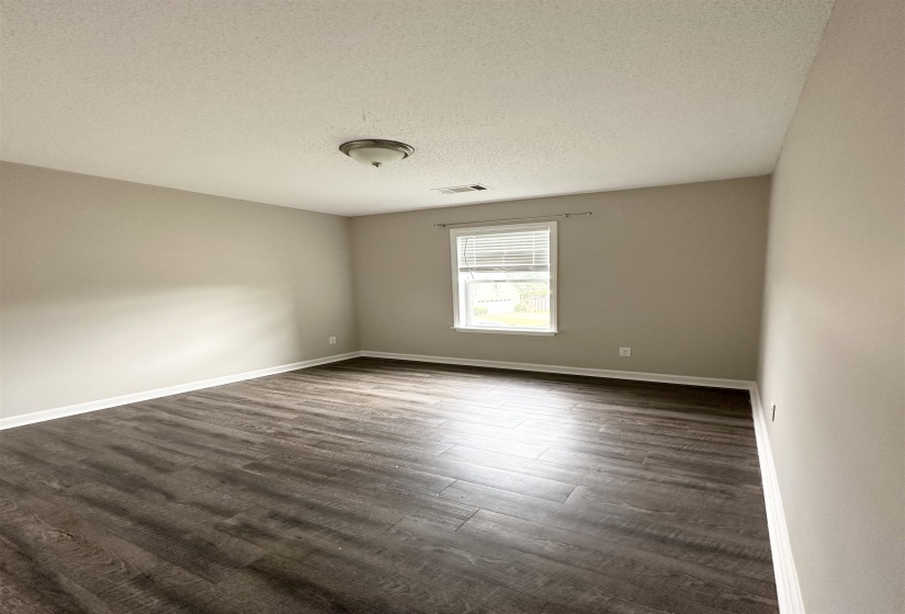 Interior room featuring wood-finish flooring and light neutral wall paint