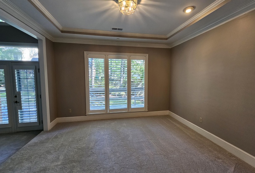 Spacious interior with neutral wall tones and light-toned carpeting