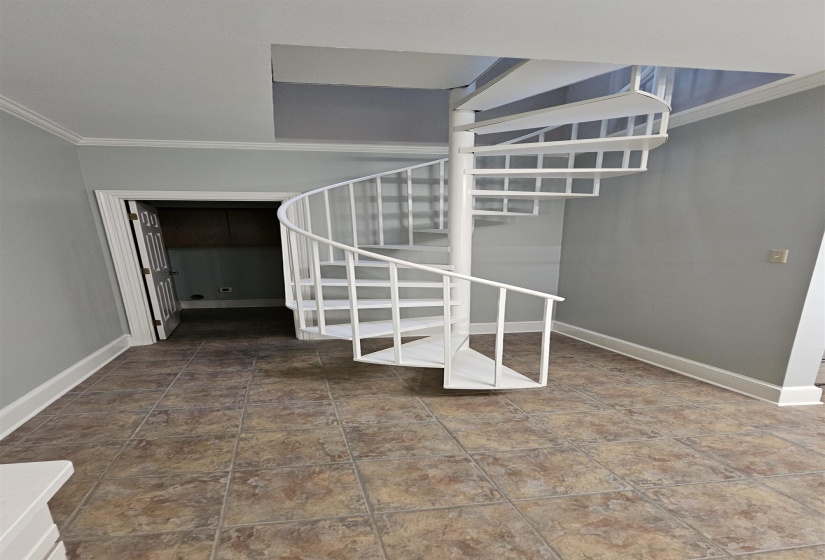 White spiral staircase with open risers and metal railing