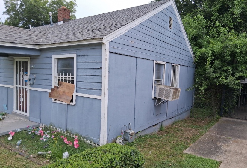 Exterior siding with a window-mounted air conditioning unit