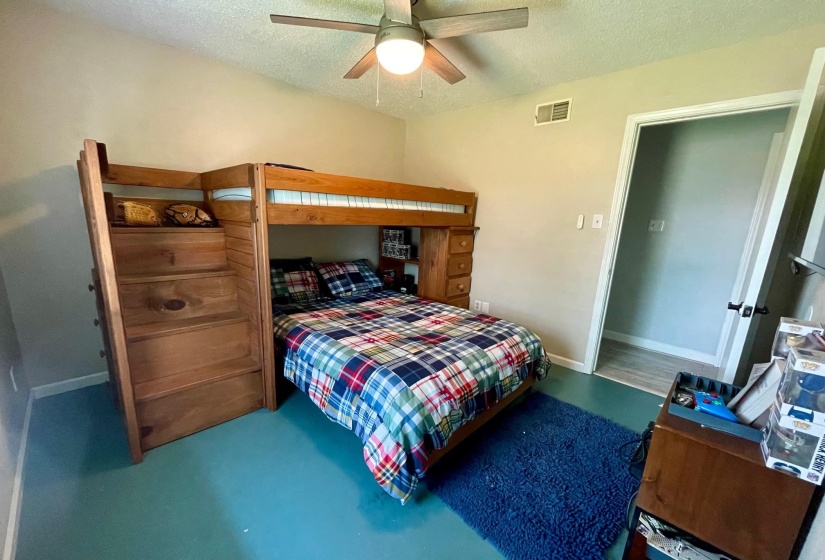 Bedroom with a textured ceiling and ceiling fan