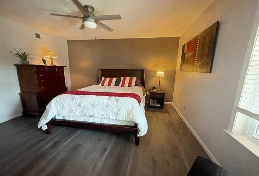 Bedroom with ceiling fan and hardwood / wood-style floors