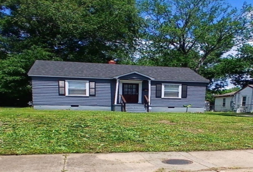 Cottage-style residence featuring horizontal siding, a gabled roofline, and front porch with steps