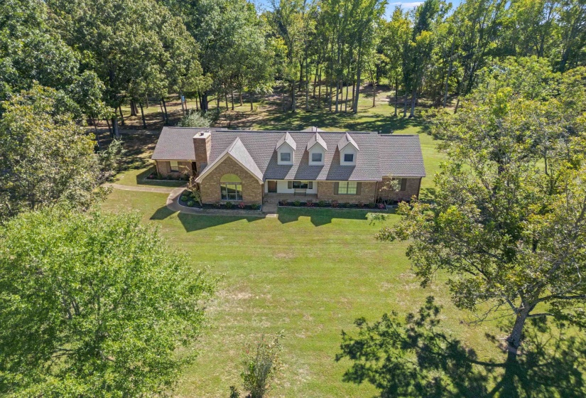 Enjoy the beauty of this sprawling 13-acre property surrounded by mature trees, open green space, and endless possibilities for country living.