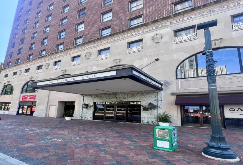 The Claridge House entrance featuring a prominent awning, stone facade, and ornate detailing