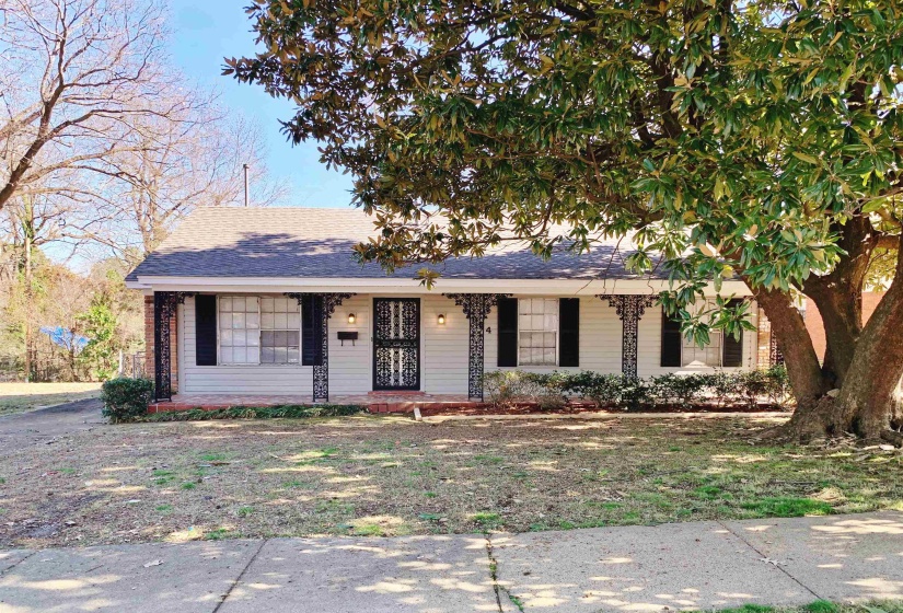 Ranch-style home featuring covered porch and roof with shingles