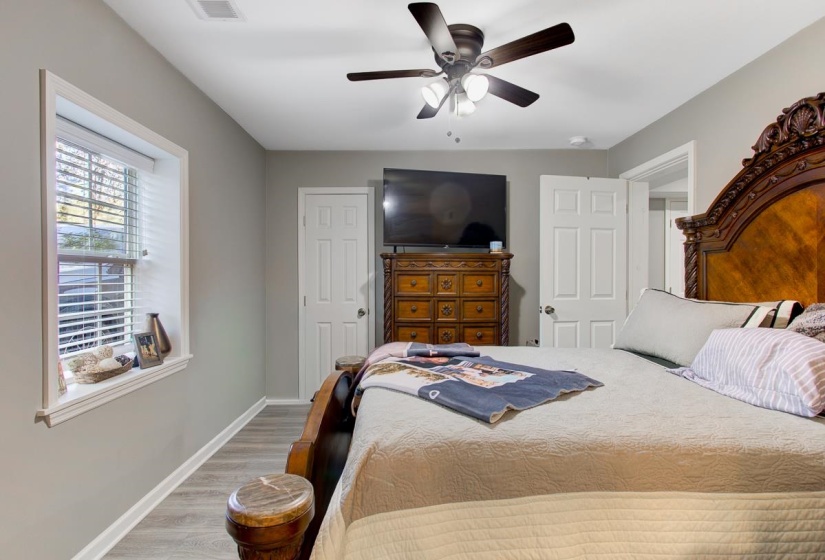 Bedroom with LVP floors and ceiling fan