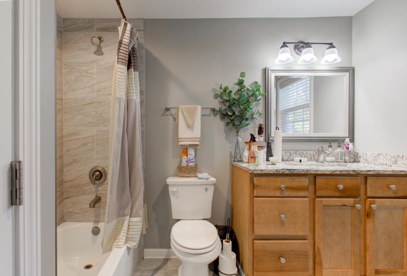 Full bath featuring vanity and shower / bath combo