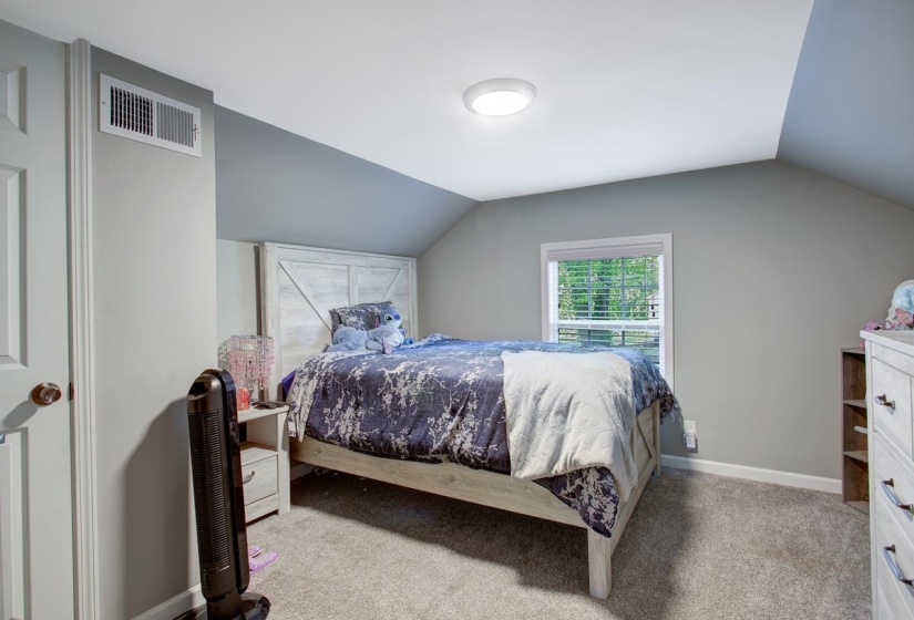 Bedroom featuring baseboards and light colored carpet. Upstairs