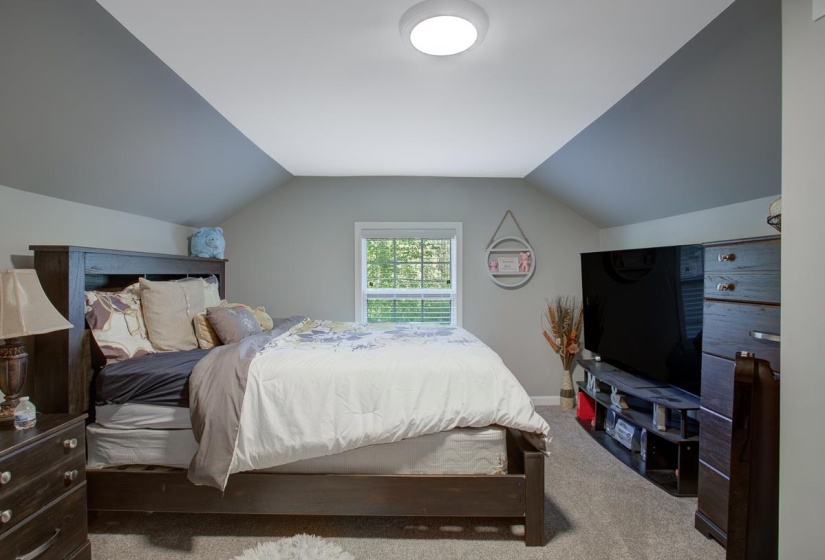 Bedroom featuring carpet. Upstairs