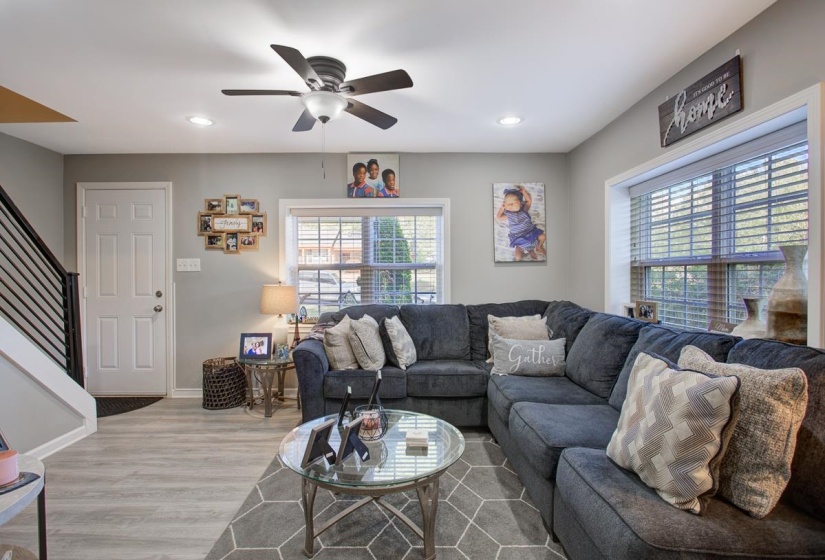 Living area with LVP floors, a ceiling fan, and recessed lighting