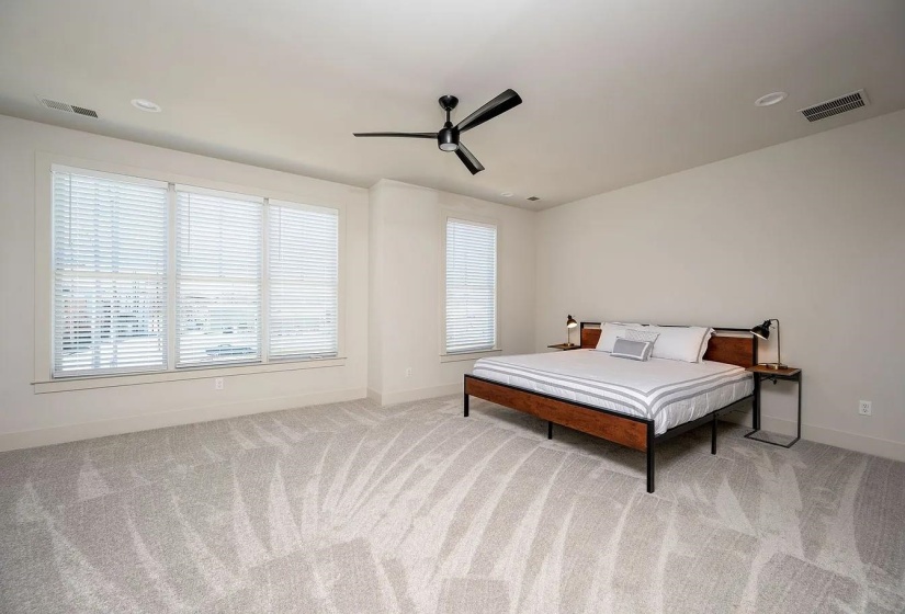 Spacious interior featuring light-toned walls and an expansive carpeted floor