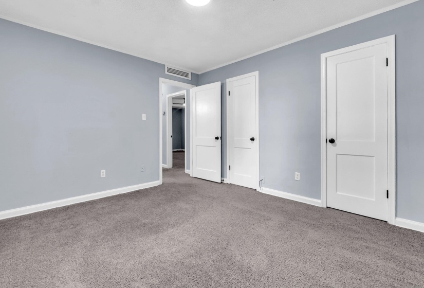 Carpeted room with light blue wall paint and white trim