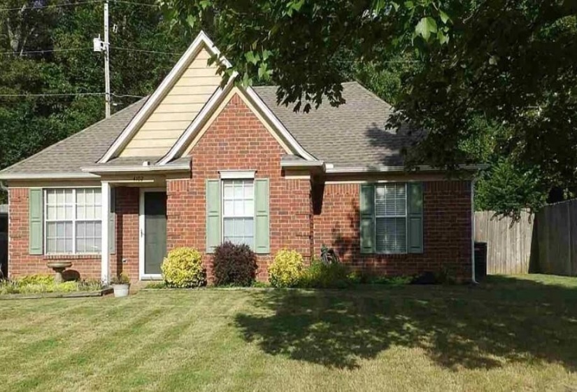 Brick exterior residence with gabled roofing and light-colored siding accents